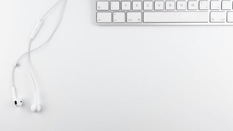 top view photo of keyboard near earphone