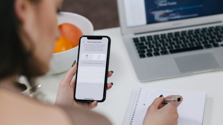 women holding space gray iphone x and black pen