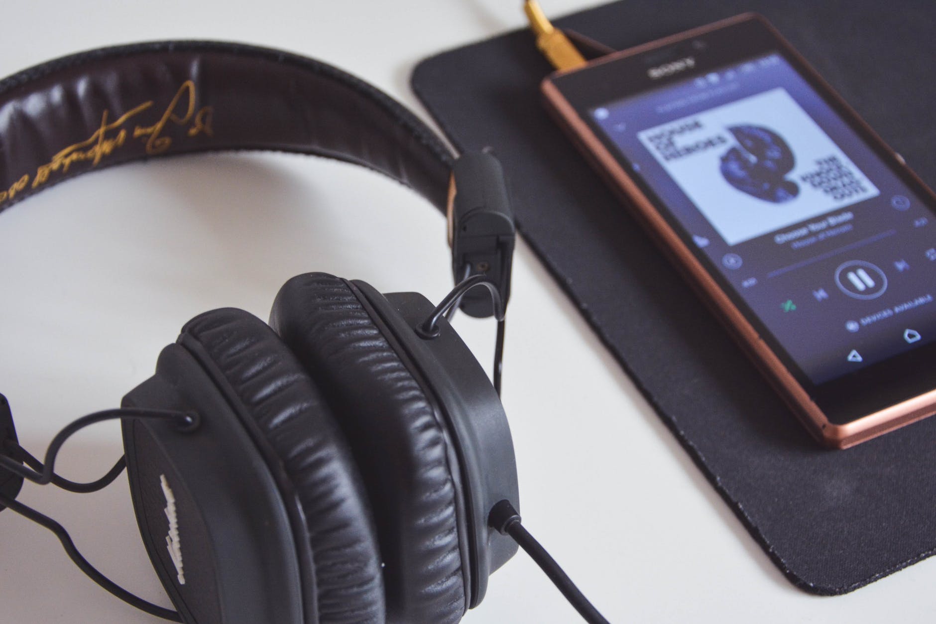black corded headphones beside sony android smartphone